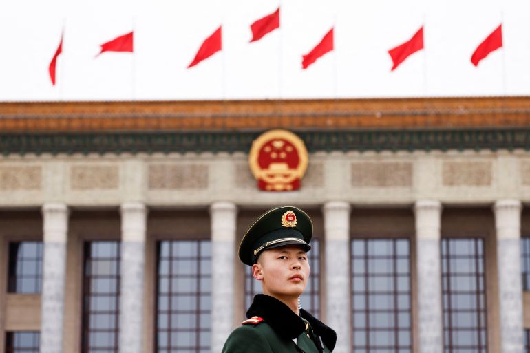 A paramilitary police officer stands guard, on the day of the opening session of the Chinese People's Political Consultative Conference (CPPCC), in front of the Great Hall of the People, in Beijing, China March 4, 2024.