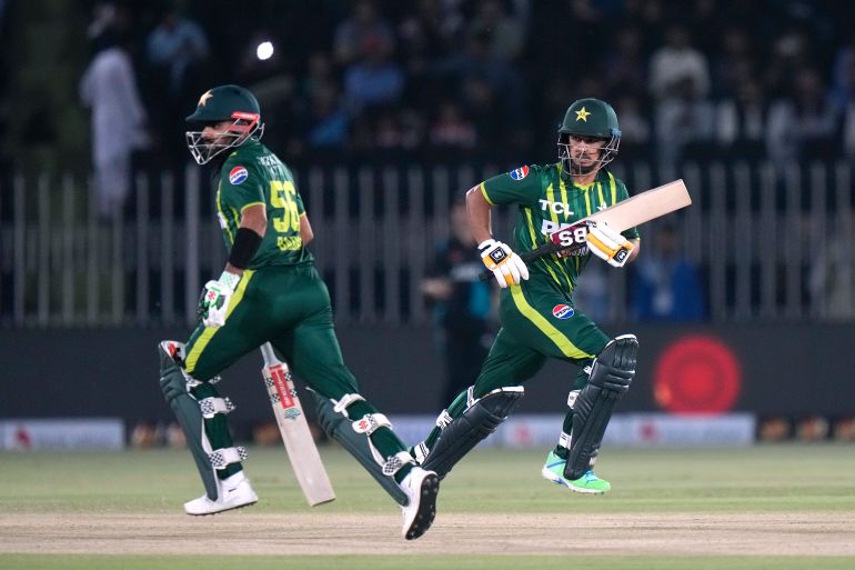 Pakistan's Saim Ayub, right, and Babar Azam run between the wickets plays a shot during the third T20 international cricket match between Pakistan and New Zealand, in Rawalpindi, Pakistan, Sunday, April 21, 2024. (AP Photo/Anjum Naveed)
