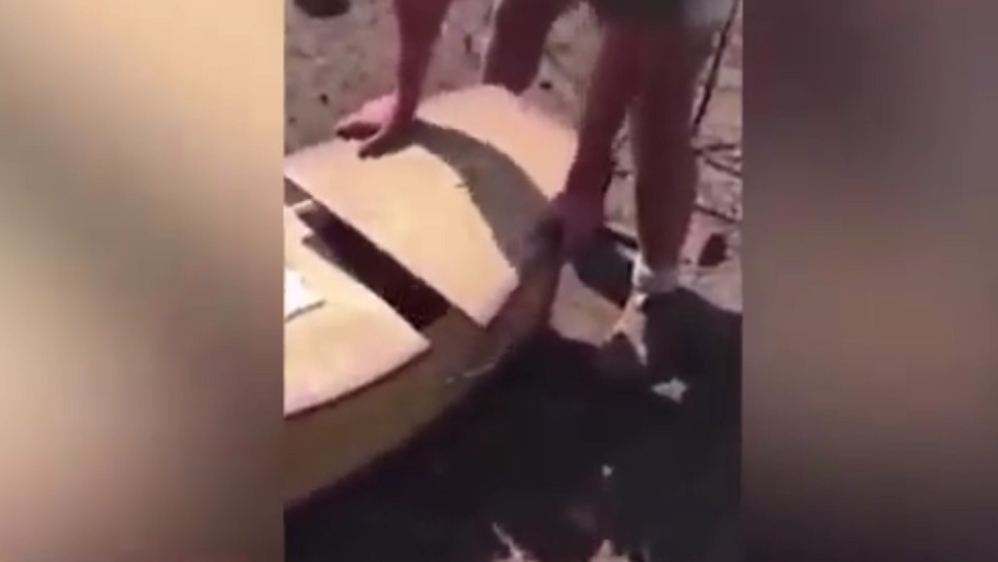 Two white men face assault charges after a video hit social media showing a black man being forced into a coffin.