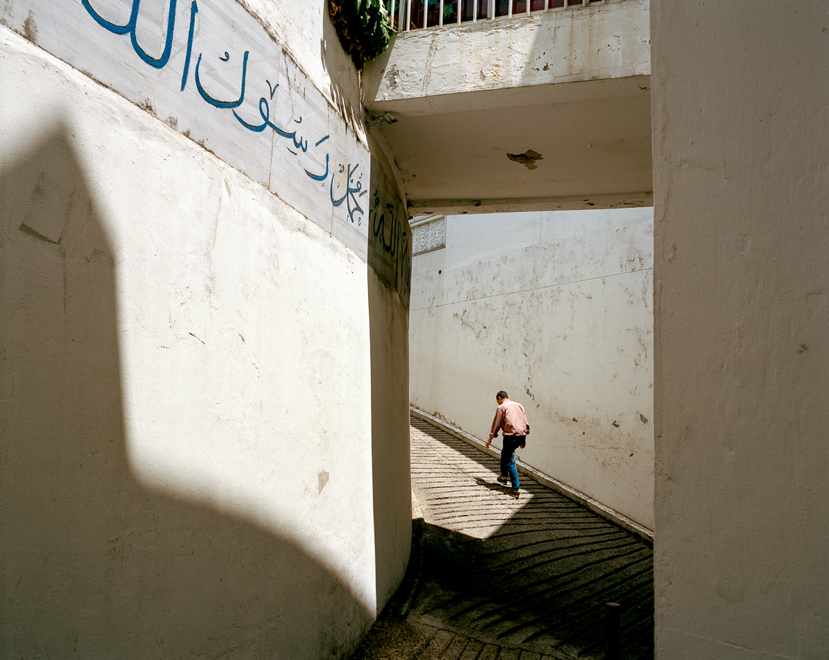A man walks up the Seoul Central Masjid in Itaewon. This Masjid was enlarged to a three-storey building in December 1991 with financial support from Islamic Development Bank, Jeddah. [Radu Diaconu/Al Jazeera]