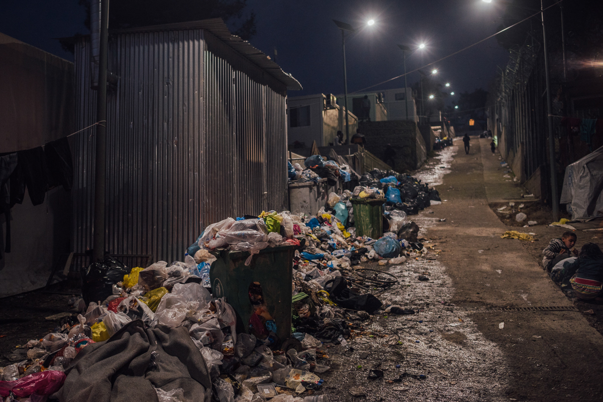 Piles of waste are spread all over the camp. Residents accuse authorities of not cleaning the designated areas every week. It is estimated that Moria camp is hosting more than 2.5 times more people than its intended capacity. [Kevin McElvaney/Al Jazeera]