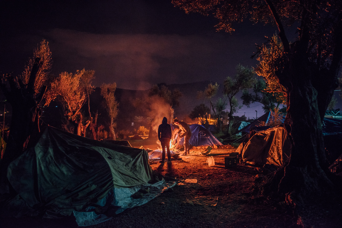 Makeshift tents spread across the olive grove outside Moria camp. People here have no access to electricity or sanitary facilities. [Kevin McElvaney/Al Jazeera]