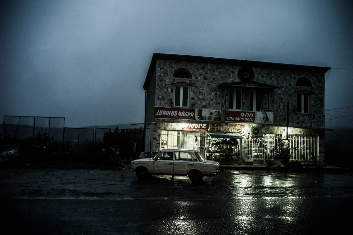 A car outside a supermarket in the town of Martuni. During the recent escalation in fighting in April 2016, many residents wanted to stay put, although many say they could hear the exchange of fire happening within the village. [Gus Palmer/Al Jazeera]