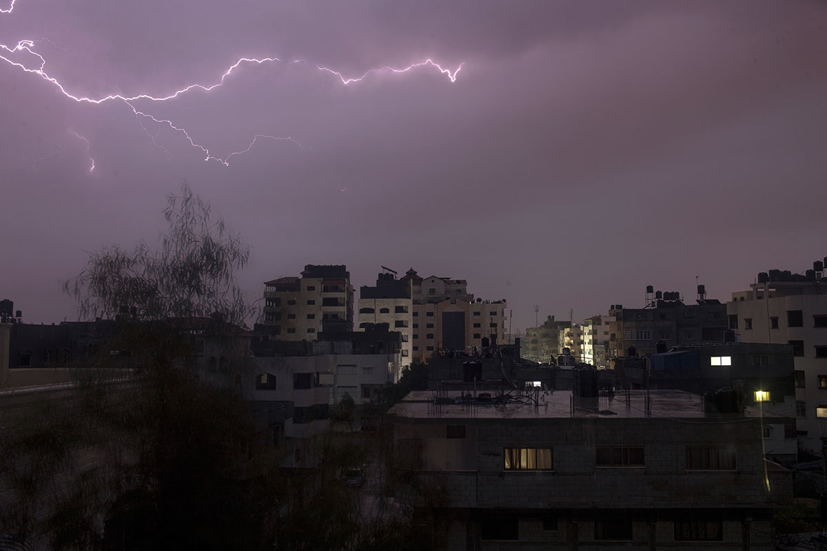 Lightning over Gaza City on Saturday during an early morning thunderstorm. [Mohammed Abed/AFP]
