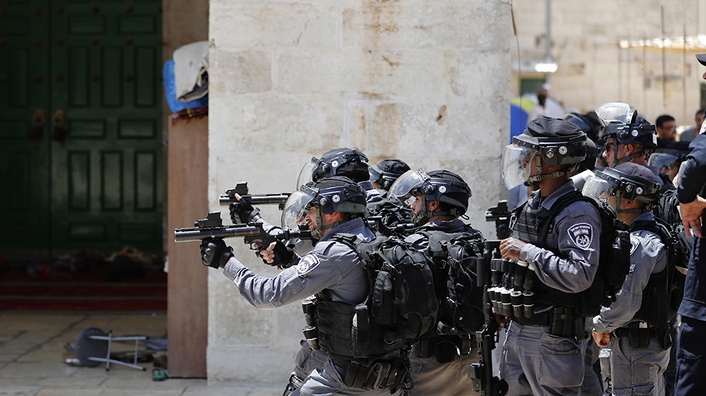 Israeli security forces aim tear gas at Palestinian protesters at the Al-Aqsa Mosque compound, in the Old City of Jerusalem on June 2, 2019, as clashes broke out while  Israelis marked Jerusalem Day. 