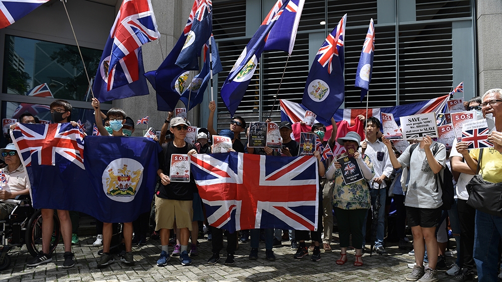 Pro-democracy demonstrators gather outside the British Consulate-General building in Hong Kong on September 15, 2019, as they called on Britain to ramp up pressure against Beijing following three mont