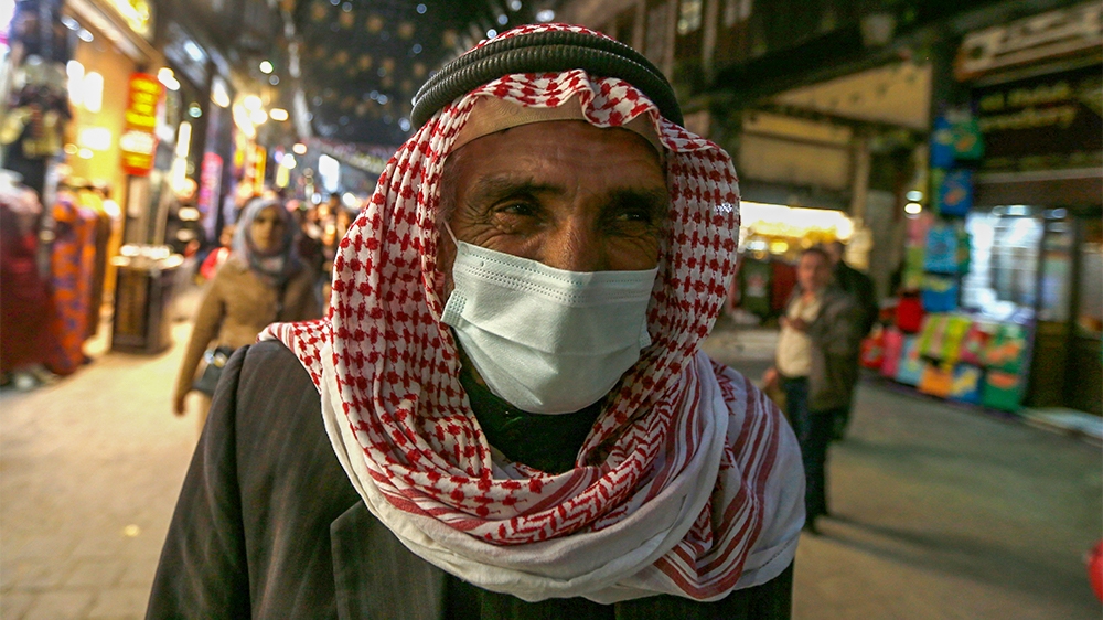 A Syrian man wearing a mask walks at the Hamidiya market in the capital Damascus' old sector on March 15, 2020. - Even though no cases of coronavirus Covid-19 have yet been reported in the city, some 