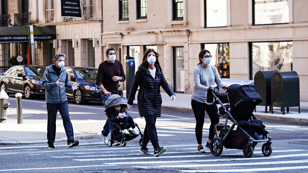 People are seen wearing protective masks and gloves during the coronavirus pandemic on April 12, 2020 in New York City. COVID-19 has spread to most countries around the world, claiming over 110,000 li