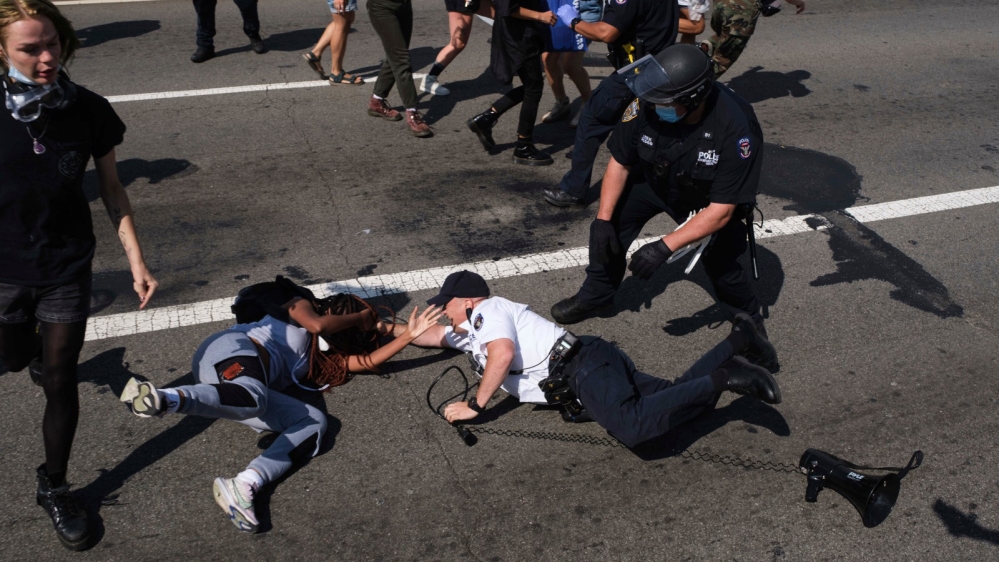 Black Lives Matter protesters are arrested by NYPD officers on the Brooklyn Bridge, Wednesday, July 15, 2020, in New York. Several New York City police officers were attacked and injured Wednesday on 
