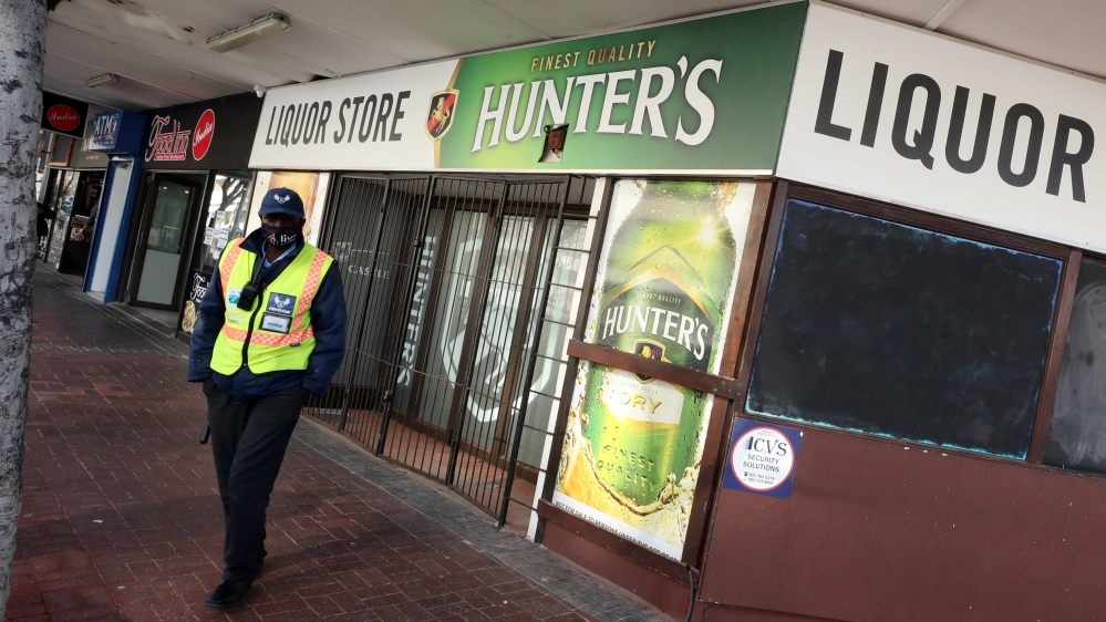 A security guard stands outside a liquor store closed under the coronavirus disease (COVID-19) lockdown regulations in Cape Town