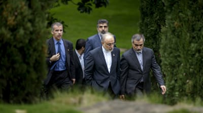Head of Iranian Atomic Energy Organization Ali Akbar Salehi talks with Hossein Fereydoon, special assistant to the Iranian president [AP]