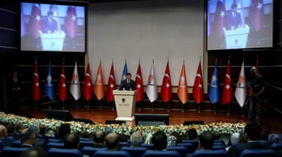 Davutoglu gives a speech during a meeting of the AK party in Ankara, Turkey on June 16 [AFP]