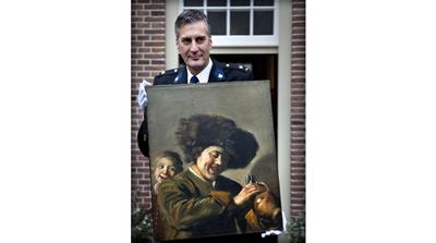 This photograph taken on November 3, 2011, shows District Chief of Alblasserwaard, Bart Willemsen showing the recovered painting 