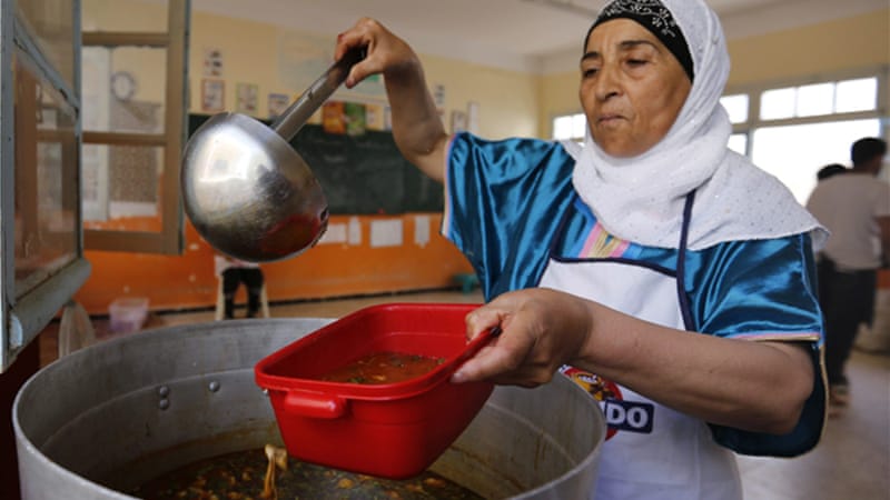 A cook serves soup in a Ramadan charity tent, outside Algiers [Reuters]