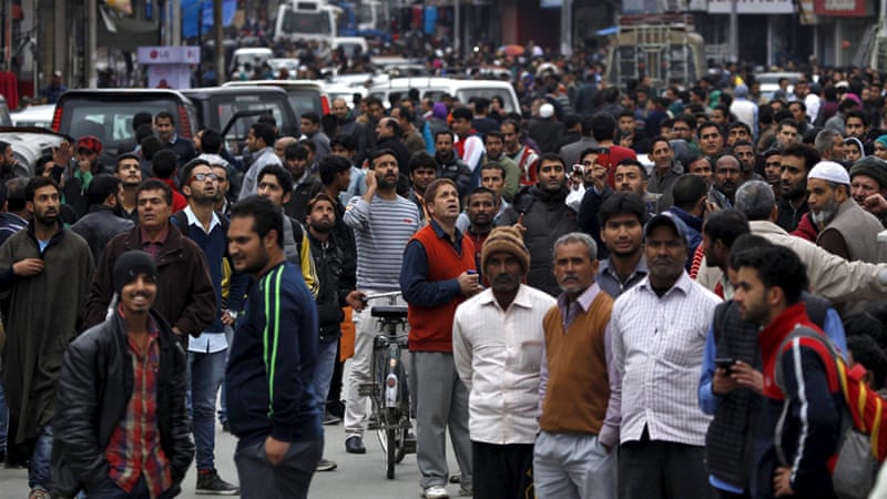 People pour out of offices into a street in India’s Kashmir after a  strong quake hit the region / Al Jazeera And Agencies