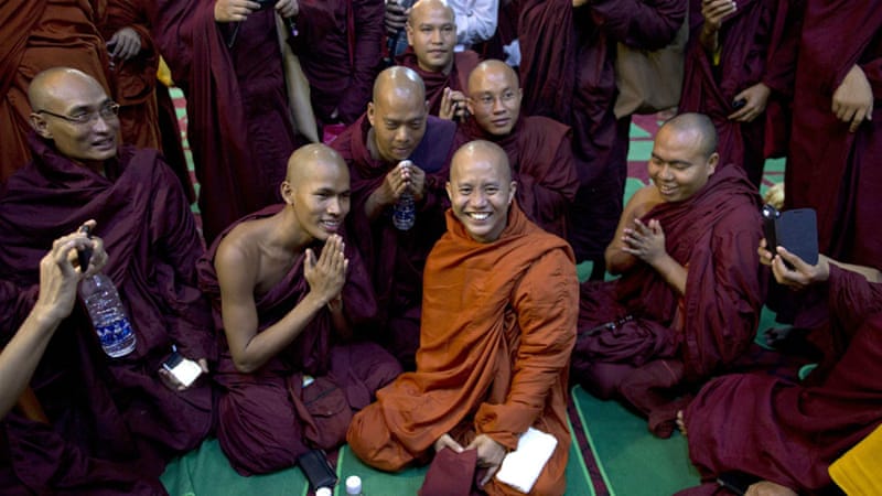 File: Wirathu, pictured in the centre, is known for his controversial statements against Muslims [Gemunu Amarasinghe/AP]