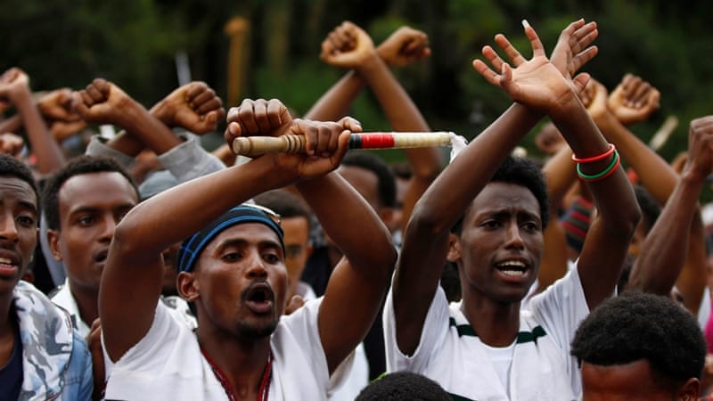 Demonstrators chant slogans while flashing the Oromo protest gesture during Irreecha, the thanksgiving festival of the Oromo people, in Bishoftu town, Oromia region, Ethiopia [Reuters]