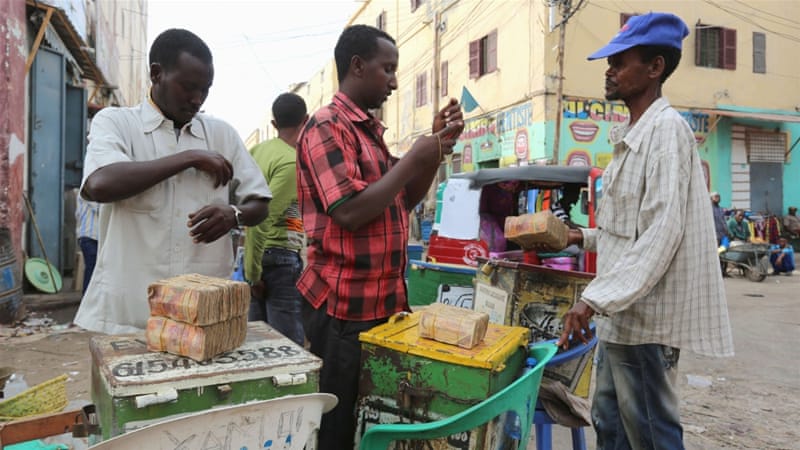 Dealers trade with bundles of Somalian currency at an open forex bureau in Somalia's capital Mogadishu [REUTERS]