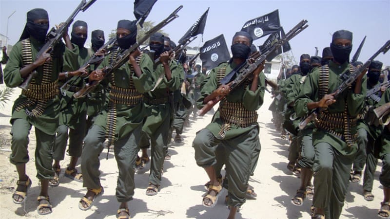Al-Shabab fighters march with their weapons during military exercises on the outskirts of Mogadishu, Somalia [AP]