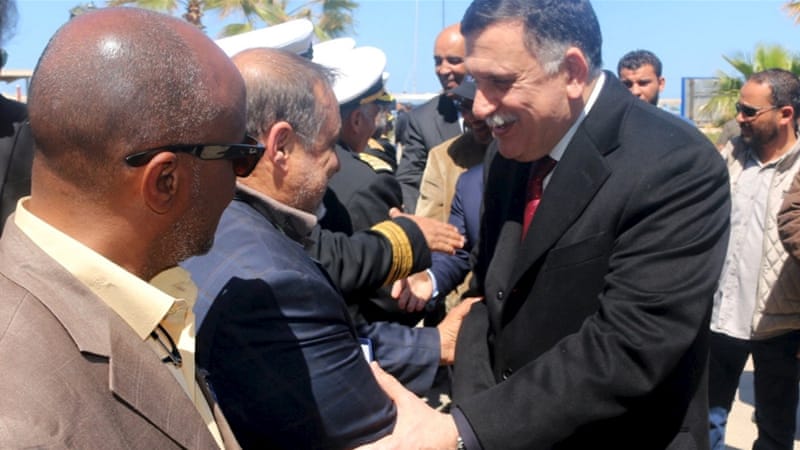 Fayez al-Sarraj is greeted upon arrival in the Libyan capital of Tripoli [Hani Amara/Reuters]