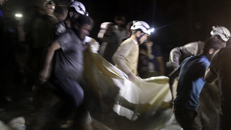 Civil defence members carry a casualty after an air strike at a field hospital near Aleppo last month [Abdalrhman Ismail/Reuters]