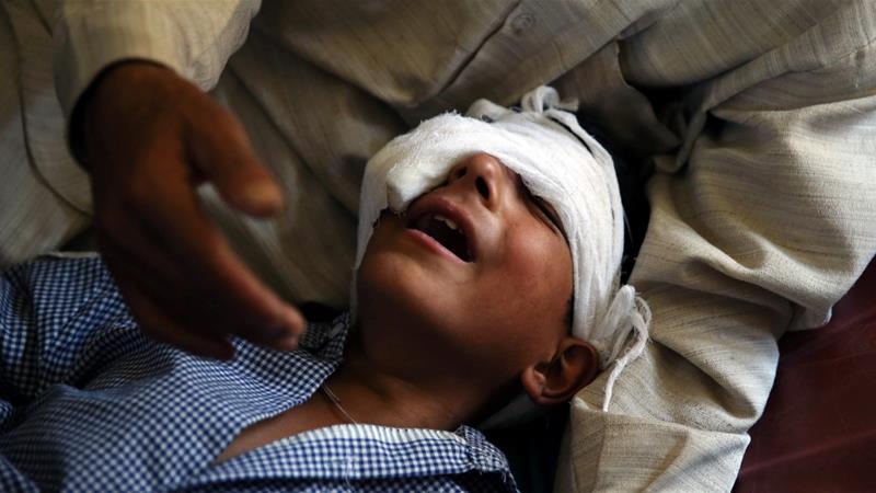 A father comforts his son who, he said, was injured by pellets shot by security forces in Srinagar following weeks of violence in Kashmir on August 18, 2016 [File Photo: Cathal McNaughton/Reuters]
