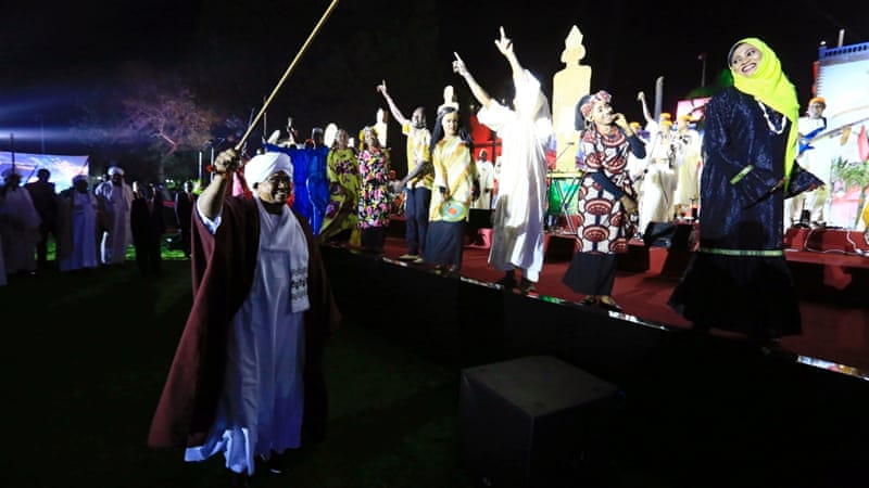 Sudan's president Omar al-Bashir waves at traditional performers after he addressed the nation during the country's 61st independence day, on December 31 [Reuters]