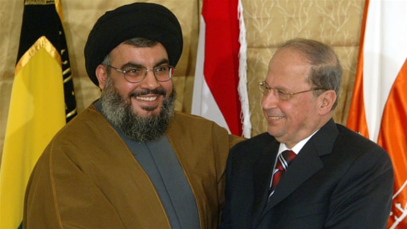 Hezbollah leader Hassan Nasrallah shakes hands with Christian leader Michel Aoun during a news conference in a church in Beirut, Lebanon on February 6, 2006 [Mohamed Azakir/Reuters]