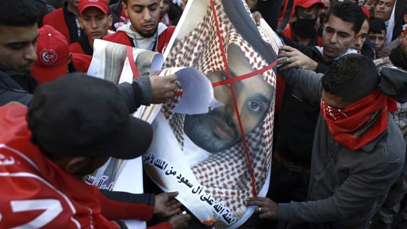 Palestinian Popular Front for the Liberation of Palestine supporters burn photos of Saudi King Salman and Saudi Deputy Crown Prince Mohammed bin Salman on December 9 [AP/Khalil Hamra]
