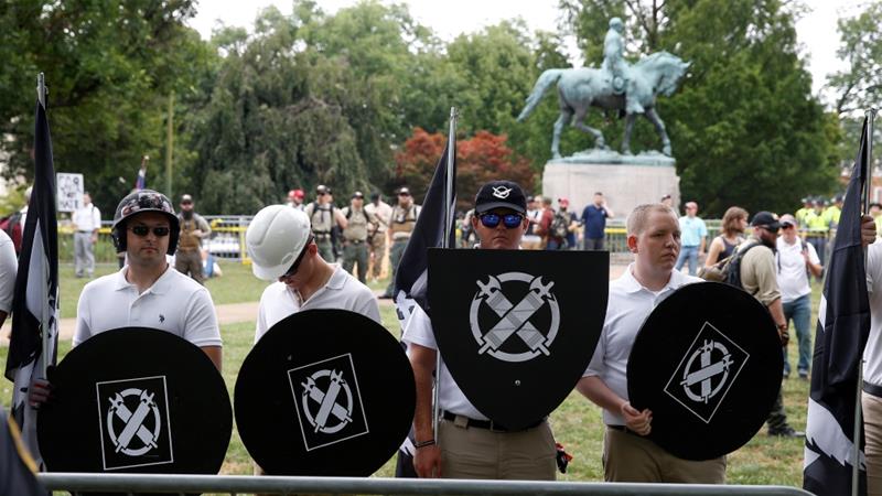 White supremacists, holding shields with a symbol of Vanguard America on them, in Charlottesville [File: Joshua Roberts/Reuters]