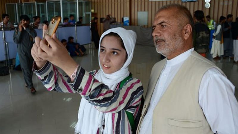 Qaderyan, pictured with her father, is angry and grieving after his death in the ISIL-claimed attack [File: Hoshang Hashmi/AFP]