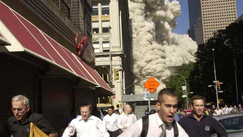 People run from the collapse of World Trade Center on Tuesday September 11, 2001 in New York City [Suzanne Plunkett/AP]