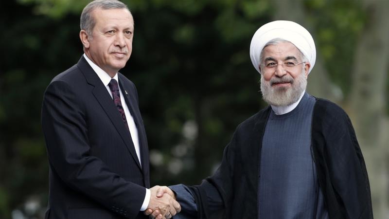 Iran's President Hassan Rouhani and Turkey's President Recep Tayyip Erdogan pose for photographs during a meeting in Ankara in 2014 [Umit Bektas/Reuters]