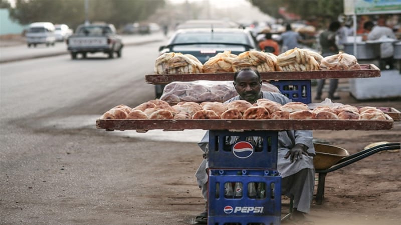 Bread prices have almost doubled in Sudan since the government stopped importing wheat from overseas [Mosa'ab Elshamy/AP]