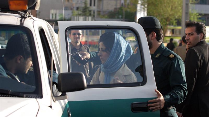 Iranian police officers detain a woman for not adhering to the dress code in Tehran back in 2007 [File: The Associated Press]