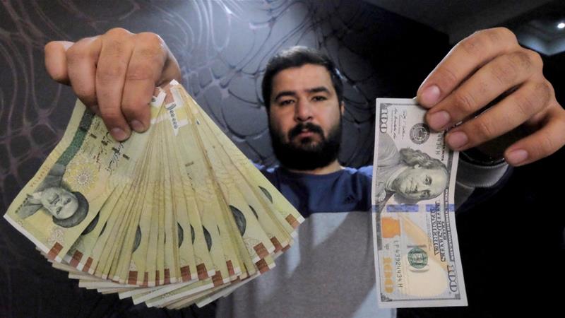 US $100 bill (R) and its equivalent in Iranian rials (L), Tehran, Iran, January 20, 2016 [Photo/Raheb Homavandi/Reuters]