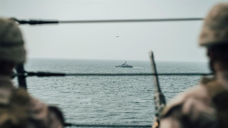 US Marines observe an Iranian fast attack craft from USS John P Murtha during a Strait of Hormuz transit, Arabian Sea off Oman [File: Handout/Donald Holbert/US Navy/Reuters] 