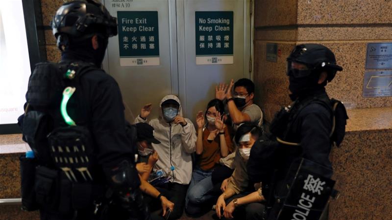 Riot police detain people during a march against Hong Kong's new national security law on July 1, 2020 [File: Tyrone Siu/Reuters]