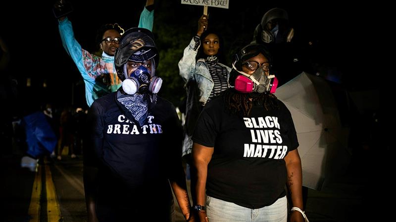 Protesters march following the release of video evidence that showed the death of Daniel Prude in police custody in the United States [File: Maranie R Staab/AFP]
