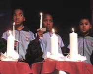 Children hold a vigil for AIDS victims