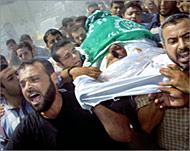 Mourners carry the body of a Hamas fighter in Gaza yesterday