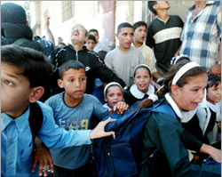 Palestinian children cry as they run away looking for a cover after an Israeli missile hita Palestinian house in a densely populated area of Gaza City on 6 September 2003. 