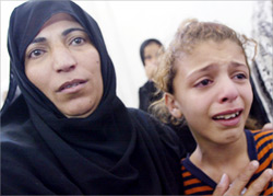 Relatives of 10-year-old Sana al-Daur mournduring her funeral on 2 September 2003 in Jabalia refugee camp, north of Gaza City. Al-Daur died from her injuries after an Israeli attack.
