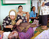 An Indonesian woman mourns afamily member killed by flooding