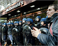 Gendarmes in riot gear guard a McDonald's restaurant  in Paris
