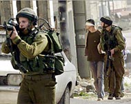 Israeli soldiers arrest a Palestinian man in the Balata refugee camp