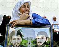  Palestinian woman holds a picture of her sons captured by Israel