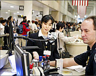 US Border Security officer taking fingerprints of a foreign national 