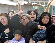 Kurdish women mourn during the funerals of PUK members 