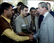 Prince Charles (R) meets Iraqi staff working at a Basra military base 